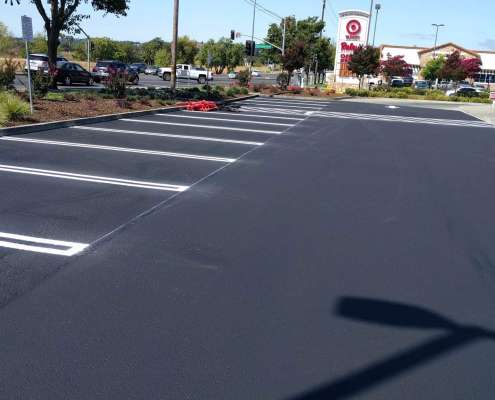 Asphalt paving and sealcoating installation in a parking lot.