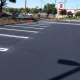 Asphalt paving and sealcoating installation in a parking lot.