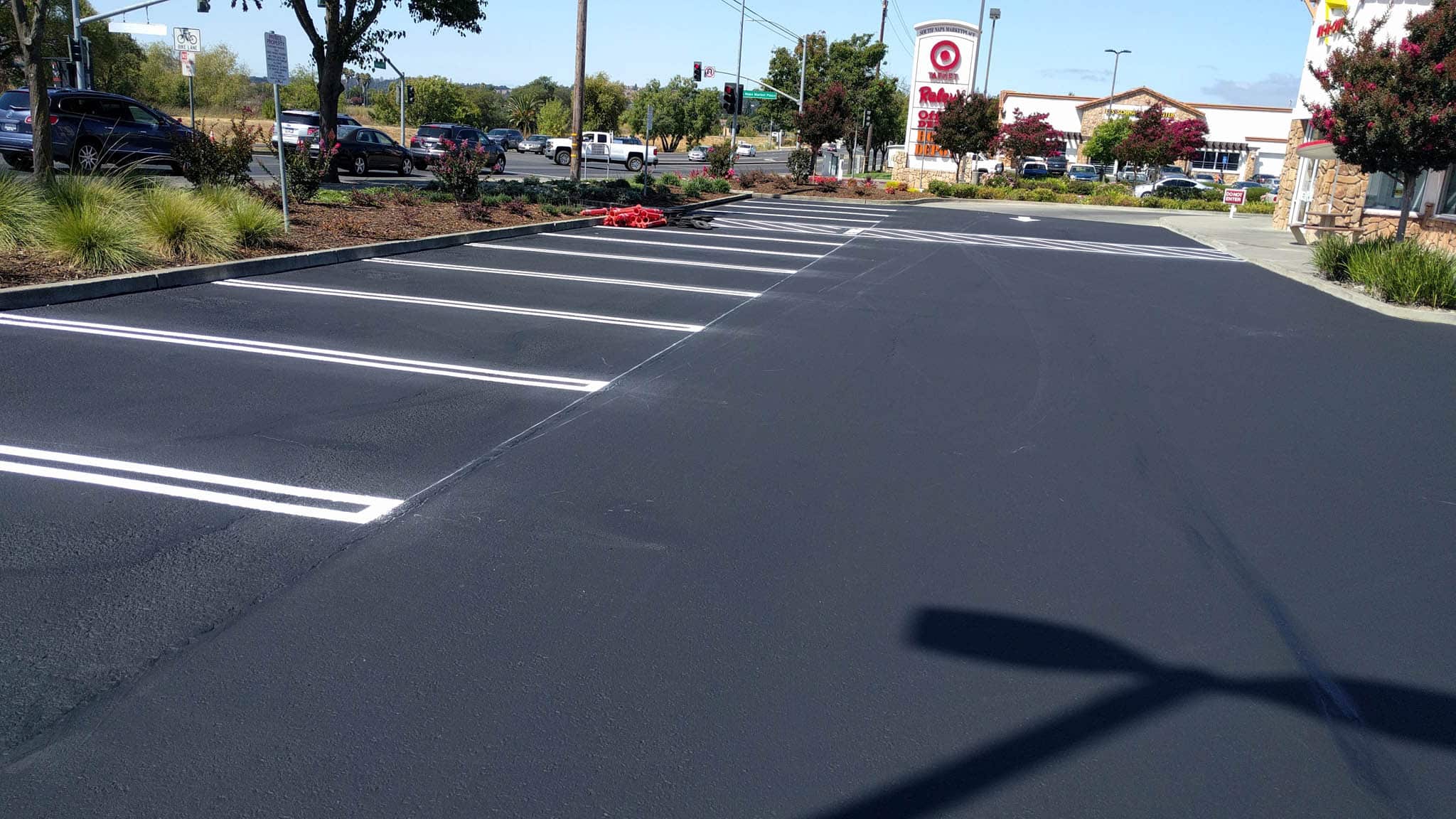 Asphalt paving and sealcoating installation in a parking lot.