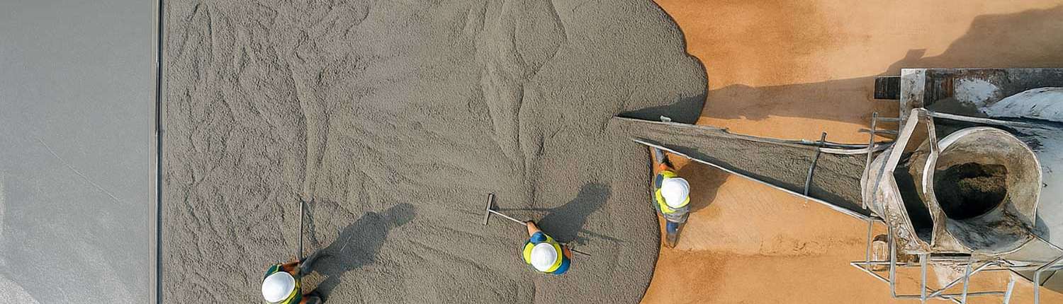 Pacific Surfacing team members pouring a wet concrete flatwork project site site