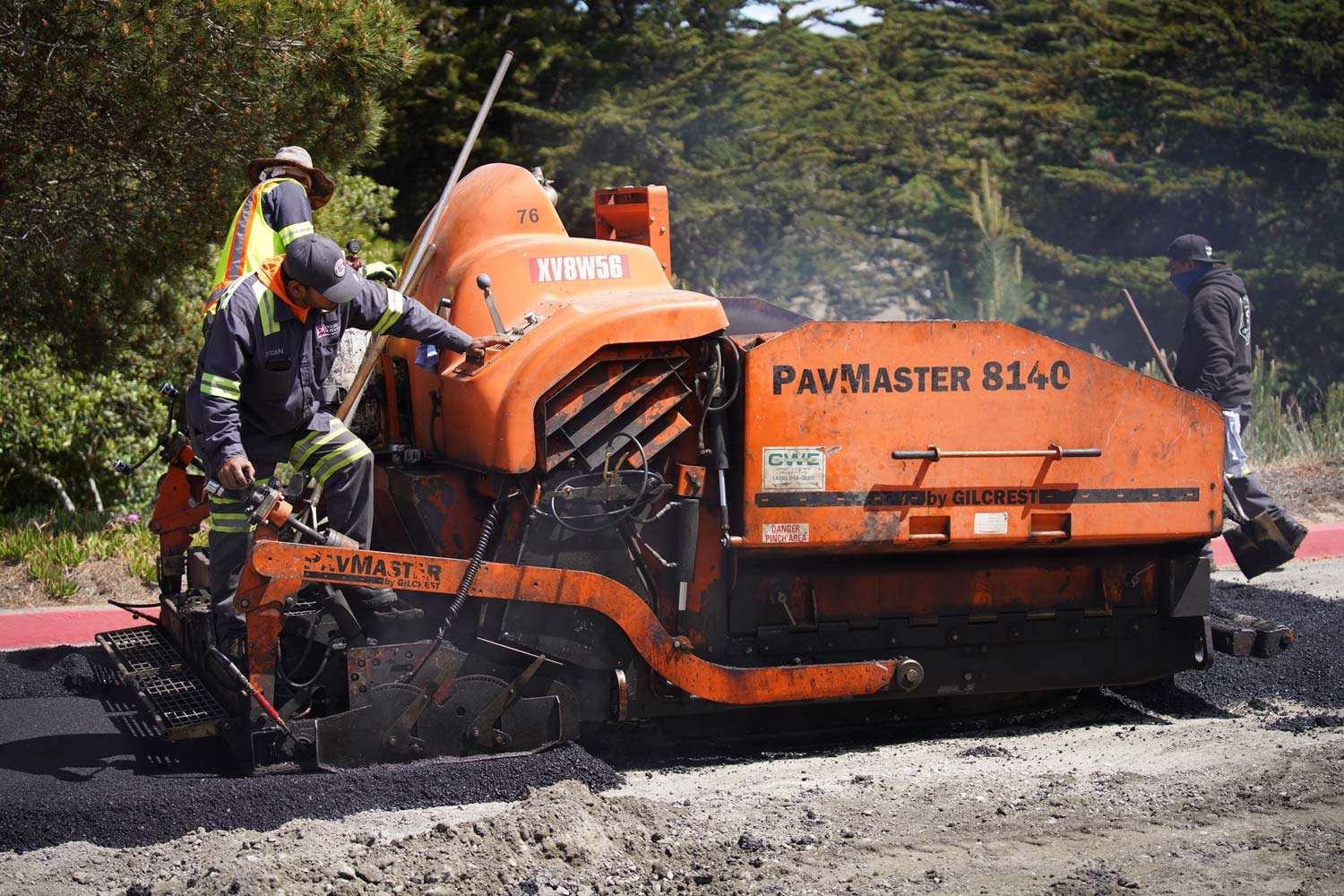 Pacific Surfacing crew members paving on a road.