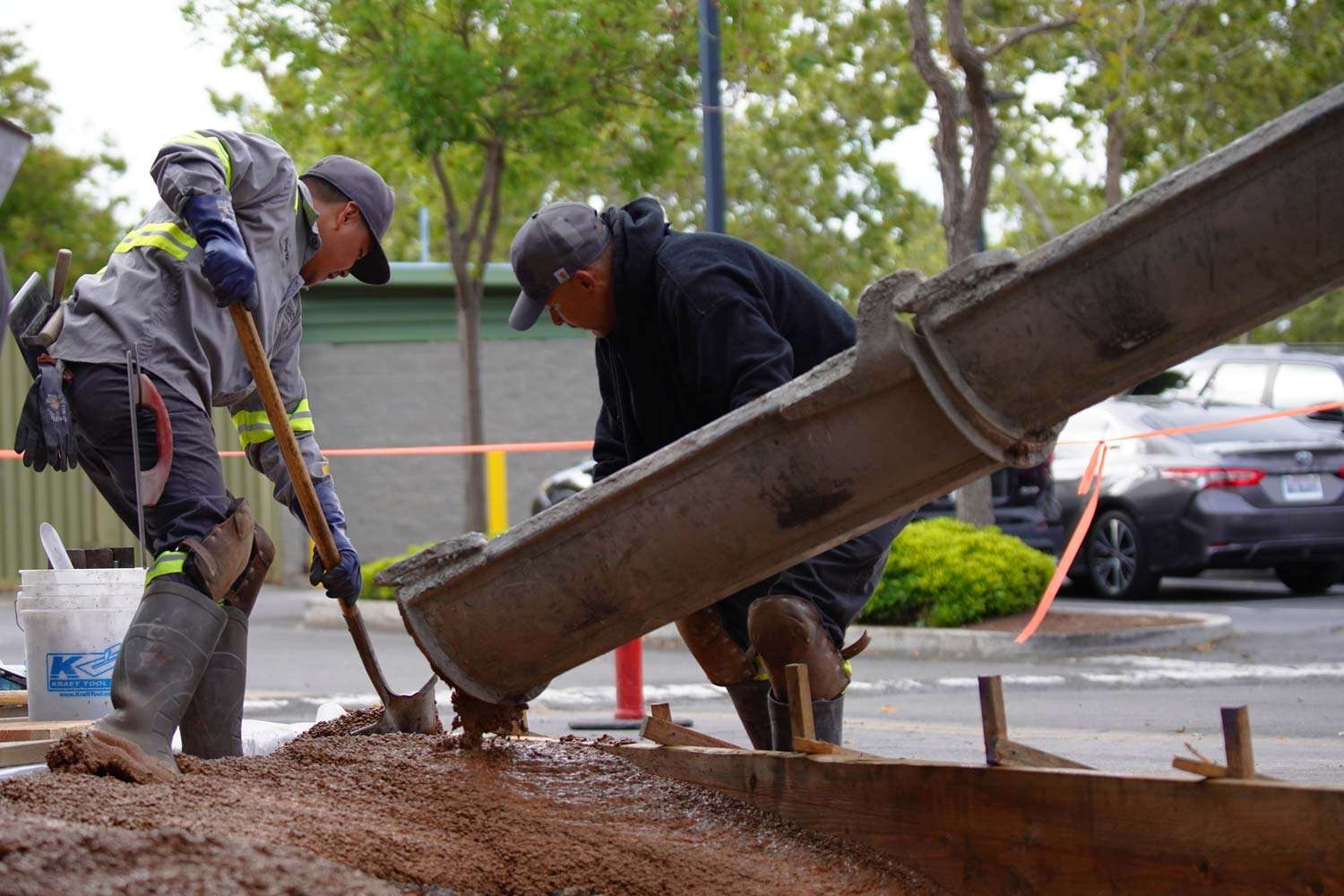 Pacific Surfacing crew members preparing and pouring concrete.