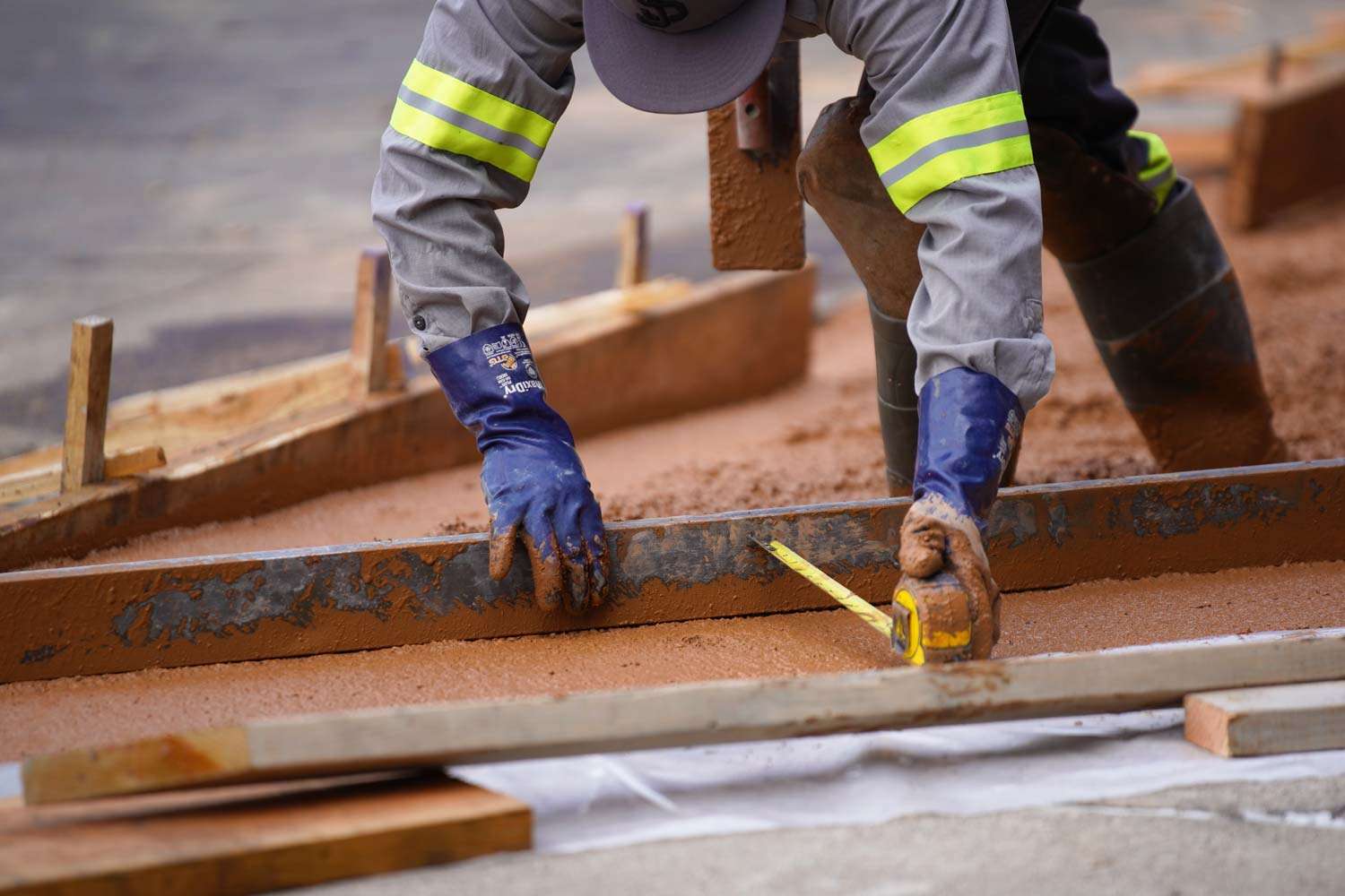 Pacific Surfacing crew member preparing and leveling concrete.