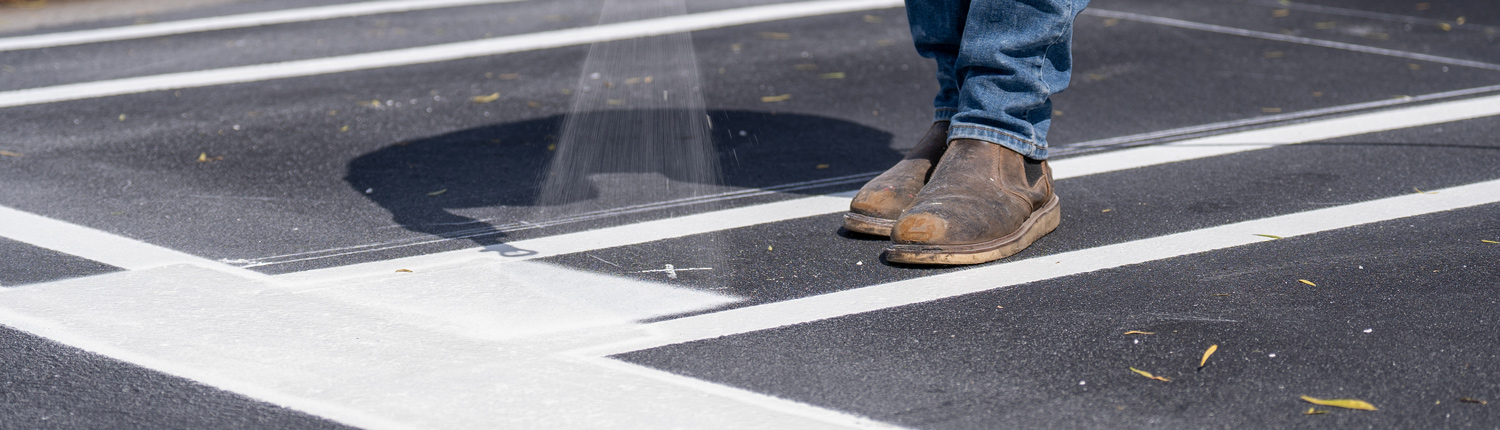 Closeup of crosswalk striping.